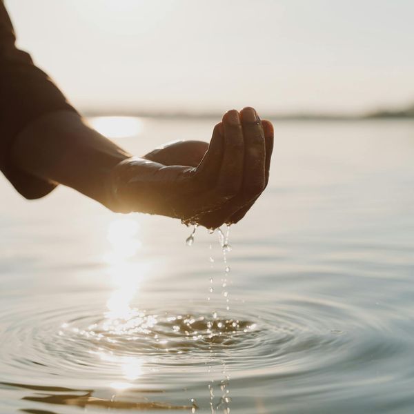 Person meditating peacefully in a bright, minimalist environment.